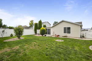 Rear view of property featuring a fenced backyard
