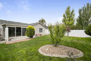 View of yard with a patio area and a sunroom