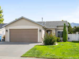 View of front of house with concrete driveway, a garage, and stucco siding
