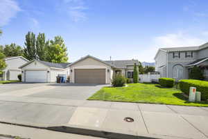 View of front of house with concrete driveway, a garage, and stucco siding