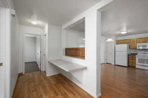 Hall featuring dark wood-style floors and a textured ceiling