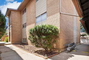 View of side of home featuring brick siding