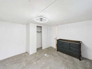 Unfurnished bedroom featuring carpet floors and a closet