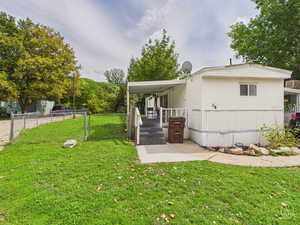 Rear view of house featuring a gate