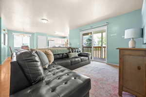 Living area with a chandelier and a textured ceiling