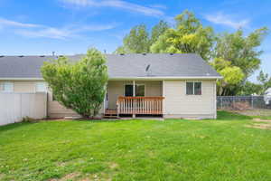 Back of property featuring a wooden deck and roof with shingles