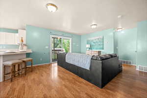Living room with light wood finished floors and a textured ceiling