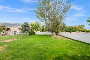 Fenced backyard featuring a mountain view