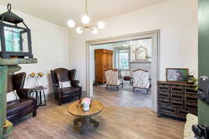 Sitting room with a chandelier and wood finished floors