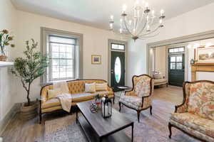 Living area with a chandelier and wood finished floors