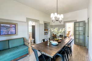 Dining area featuring a chandelier and light wood-style flooring