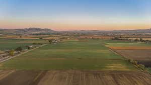 Aerial view at dusk of a view of countryside, a mountain view, and agricultural plots