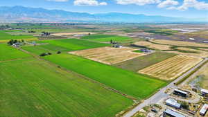 View of rural area featuring a mountainous background and large plots for crops