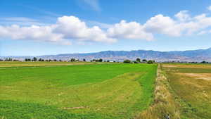 View of mountain background featuring a pastoral area and rural landscape