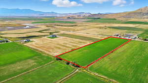 View of rural area featuring a mountain backdrop, property boundaries highlighted, and abundant farmland