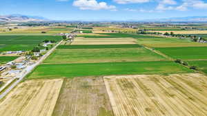Aerial view of sparsely populated area featuring mountains and large plots for crops