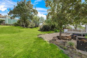 View of green lawn with a deck