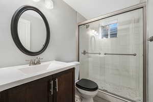Bathroom with vanity and a stall shower