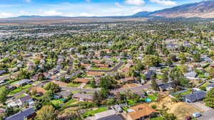 Aerial view of property's location with a mountain backdrop and nearby suburban area