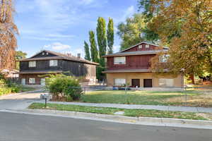 View of front of house featuring brick siding and a fenced front yard