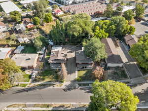 Aerial view of property and surrounding area with nearby suburban area