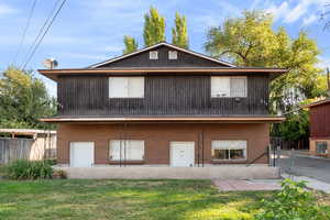 Back of house featuring brick siding