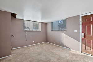 Basement with carpet flooring and baseboards