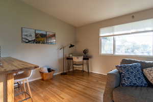 Home office with light wood finished floors and baseboards
