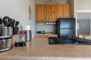 Kitchen featuring black appliances and light countertops