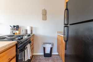 Kitchen featuring black appliances and light countertops