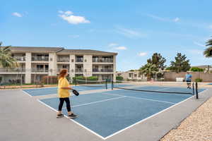 View of tennis court featuring community basketball court