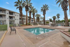 Community pool featuring a patio