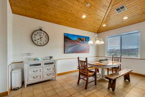 Dining room with wooden ceiling, light tile patterned flooring, recessed lighting, a chandelier, and lofted ceiling