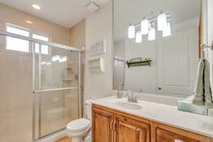 Full bath featuring a stall shower, vanity, and recessed lighting
