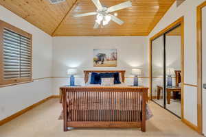 Bedroom featuring an office area, carpet floors, a closet, a ceiling fan, and vaulted ceiling