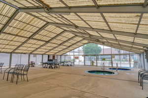 View of community featuring a jacuzzi and a patio area