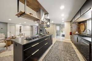 Kitchen with modern cabinets, dark cabinetry, stainless steel appliances, a spacious island, and recessed lighting