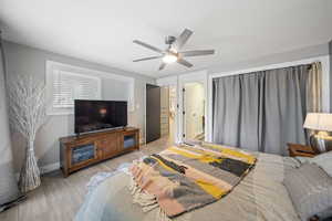 Bedroom with light wood-style flooring and a ceiling fan