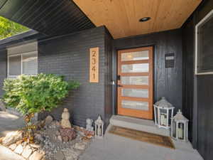 Entrance to property featuring brick siding