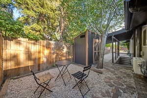 Fenced backyard with a patio area and a shed