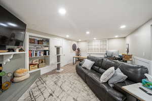 Living room featuring an office area, light wood-type flooring, and recessed lighting