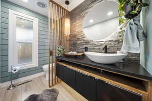 Full bath featuring vanity, light wood finished floors, and recessed lighting