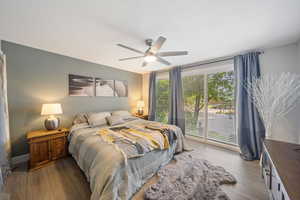 Bedroom featuring wood finished floors, ceiling fan, and access to outside