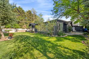 View of grassy yard featuring a patio