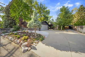 View of front of property featuring a garage and concrete driveway
