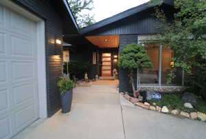 Property entrance with brick siding and a garage