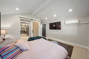 Bedroom with recessed lighting, a barn door, carpet floors, and a wall unit AC