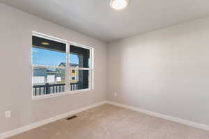 Empty room featuring carpet floors and baseboards