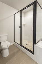 Full bath featuring a stall shower, tile patterned flooring, and a garden tub