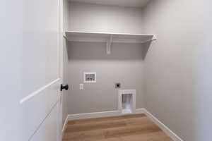 Laundry room featuring electric dryer hookup, light wood finished floors, and washer hookup